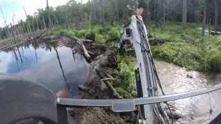 Busting A Beaver Dam Mini Bobcat Excavator Mud Stuck Water Creek [upl. by Weingartner]